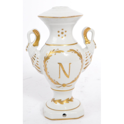 19 - Three pieces of Limoges Porcelain to include: a pair of urns / vases with white ground, decorated in... 