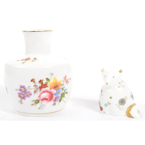 19 - Three pieces of Limoges Porcelain to include: a pair of urns / vases with white ground, decorated in... 