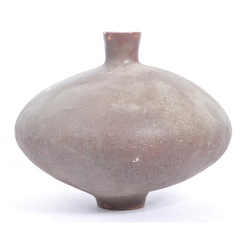 20 - A large mid 20th century brutalist narrow neck studio pottery vase. Of squat stone glaze form with t... 