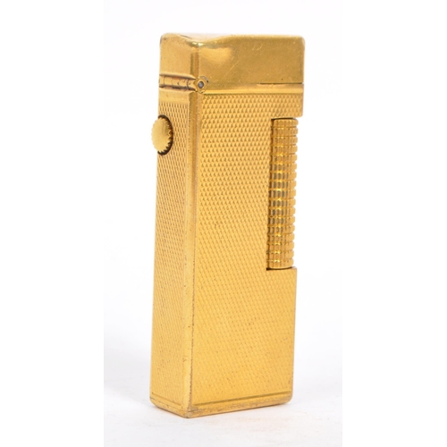 Dunhill A 20th century Dunhill Swiss made gold plated cigarette lighter. The lighter having engine