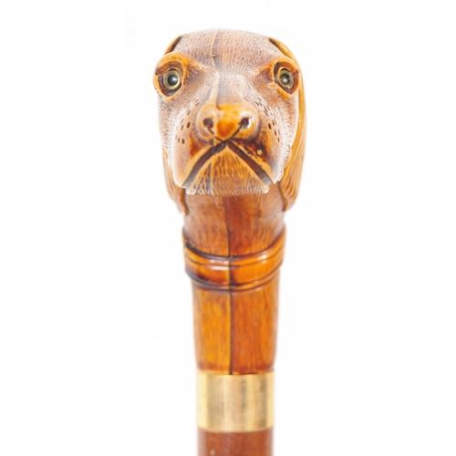 363 - A 20th century walking stick having handle carved in the from of a dogs head with amber glass bead e... 