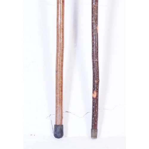 364 - A collection of early 20th century and later walking sticks to include a example with carved horse h... 