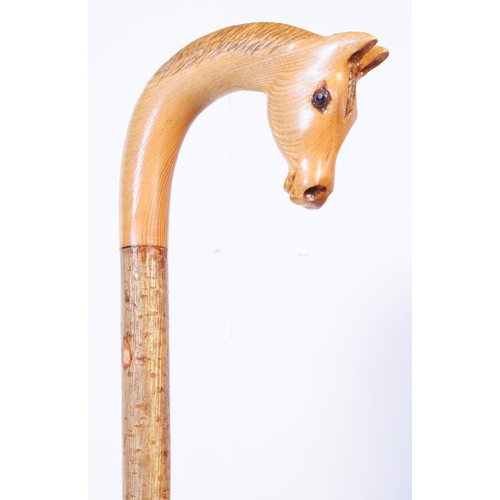 364 - A collection of early 20th century and later walking sticks to include a example with carved horse h... 