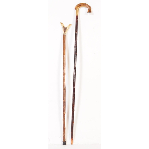 365 - Two early 20th century walking sticks to include example with handle carved from bone in the from of... 