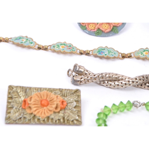 369 - A varied range of 20th century brooches, necklaces in a variety of materials which includes an item ... 