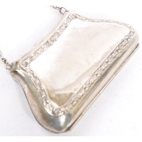 379 - Two silver plated purses. One having an etched scrolled design with central vacant cartouche. The  o... 