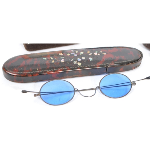 385 - A collection of early 20th century and later vintage eyewear and accessories. To include two pairs o... 