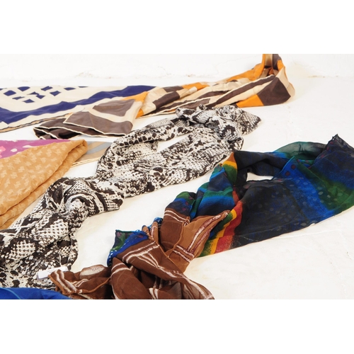 394 - A collection of vintage scarves and a handkerchief. The lot to include a hand rolled and stitched we... 