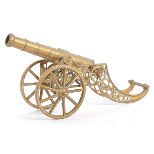 410a - A large early 20th century brass desk top cannon. The brass cannon set over a brass carriage with la... 