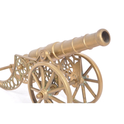 410a - A large early 20th century brass desk top cannon. The brass cannon set over a brass carriage with la... 