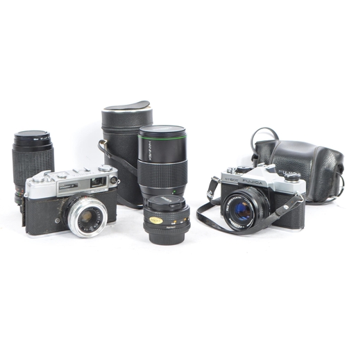 450 - A collection of vintage 20th century 35mm cameras and lenses. The lot to include a Yashica Minister-... 