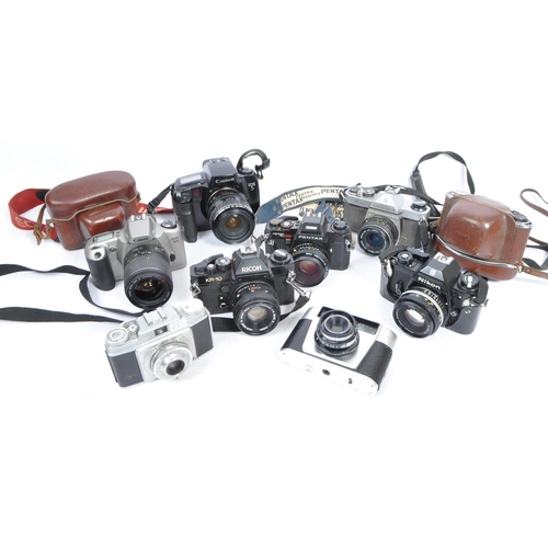 453 - A large collection of 20th century 35mm cameras. The lot to include a Canon EOS 3000N 35mm SLR camer... 