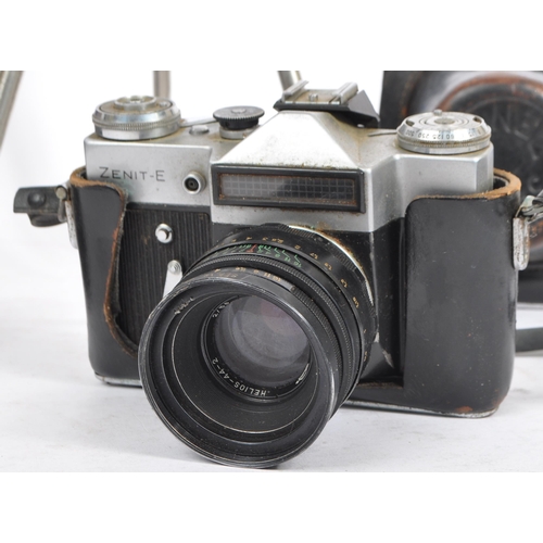 454 - A collection of 20th century cameras. The lot to include a Zenit E 35mm SLR camera with Helios-44-2 ... 