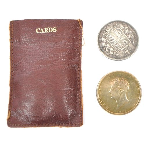 523 - An 1885 Queen Victorian silver half crown coin and an 1826 replica King George IV coin brooch. Weigh... 