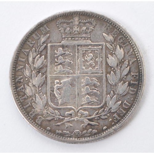 523 - An 1885 Queen Victorian silver half crown coin and an 1826 replica King George IV coin brooch. Weigh... 