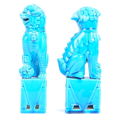 71 - A pair of 20th Century Chinese  / Oriental figural foo dogs. The temple lions  raised on pedestal ba... 