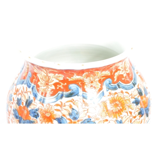 89 - A pair of late 19th century Japanese Imari urn vases. The vases featuring blue and red floral motifs... 