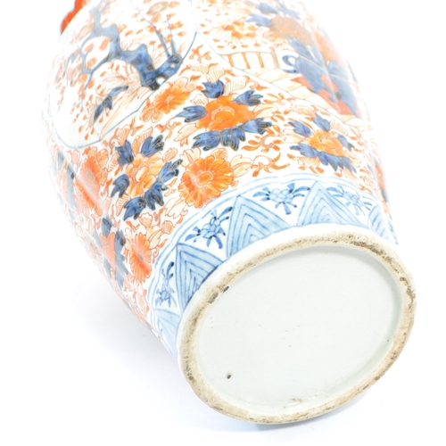 89 - A pair of late 19th century Japanese Imari urn vases. The vases featuring blue and red floral motifs... 