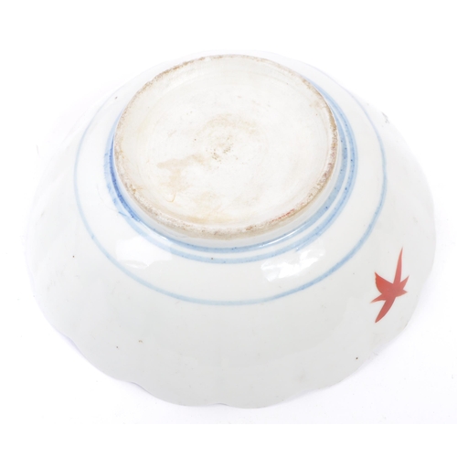 91 - A pair of early 20th century Chinese bowls with floral shaped rims, featuring six segments of patter... 