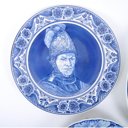 93 - Three early 20th century continental delftware blue & white chargers, to include one featuring a you... 