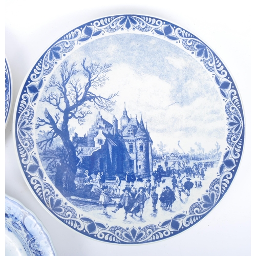 93 - Three early 20th century continental delftware blue & white chargers, to include one featuring a you... 