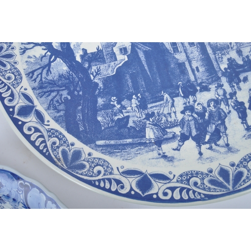 93 - Three early 20th century continental delftware blue & white chargers, to include one featuring a you... 