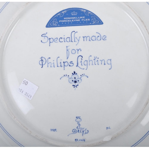 93 - Three early 20th century continental delftware blue & white chargers, to include one featuring a you... 