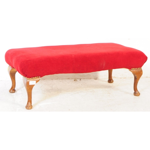 1053 - A vintage 20th century Queen Anne revival footstool. Of rectangular form with red material upholster... 