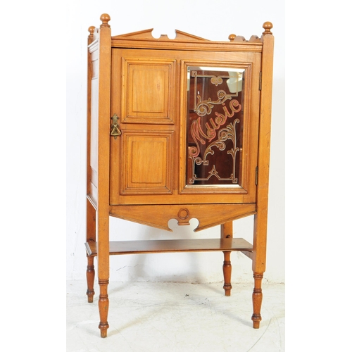 1054 - An early 20th century oak Edwardian music cabinet. Of rectangular form with shaped gallery back and ... 