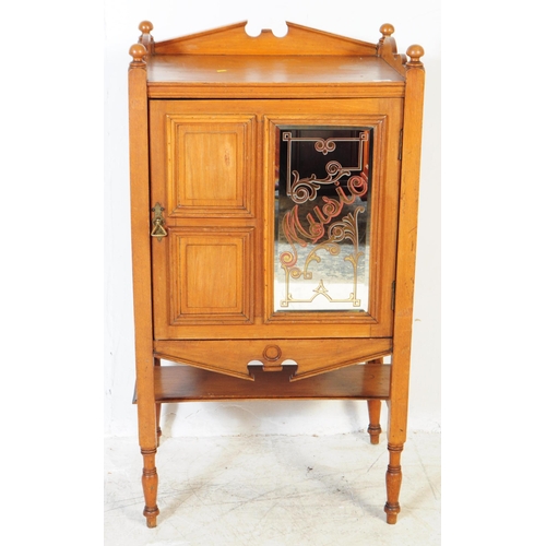 1054 - An early 20th century oak Edwardian music cabinet. Of rectangular form with shaped gallery back and ... 