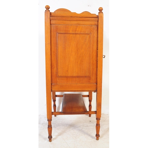 1054 - An early 20th century oak Edwardian music cabinet. Of rectangular form with shaped gallery back and ... 