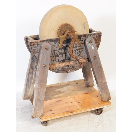 1066 - A Victorian 19th century knife / cleaver sharpening wheel. Having a wooden frame with four angled le... 