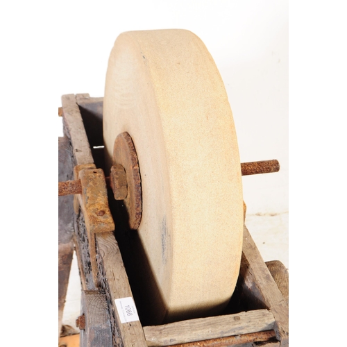 1066 - A Victorian 19th century knife / cleaver sharpening wheel. Having a wooden frame with four angled le... 