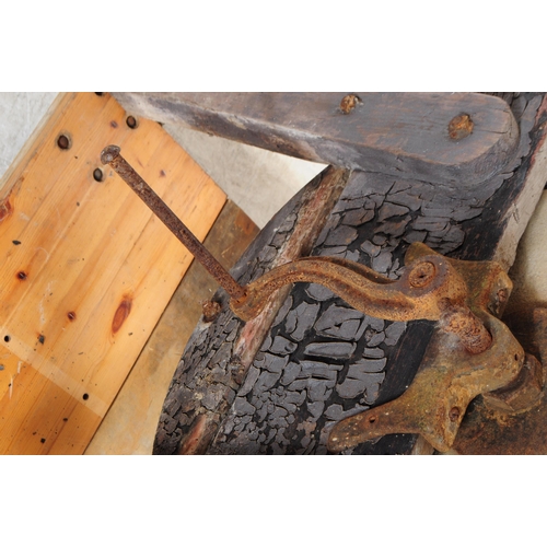 1066 - A Victorian 19th century knife / cleaver sharpening wheel. Having a wooden frame with four angled le... 