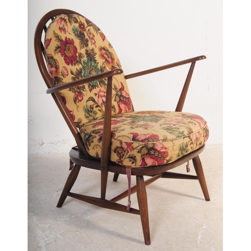 554 - Ercol Furniture - A pair of retro mid 20th century beech and elm low easy armchairs. With arched spi... 