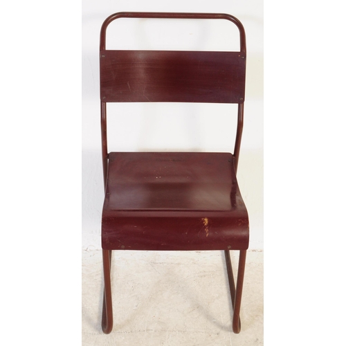 557 - A set of seven Du-al retro mid 20th century stacking industrial school chairs. Having tubular metal ... 