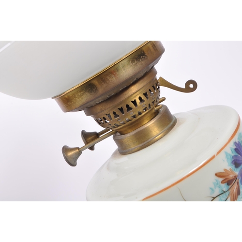 566 - W&S Best - A 20th century cast metal and floral decorated opaline glass duplex oil lamp by W&S Best,... 