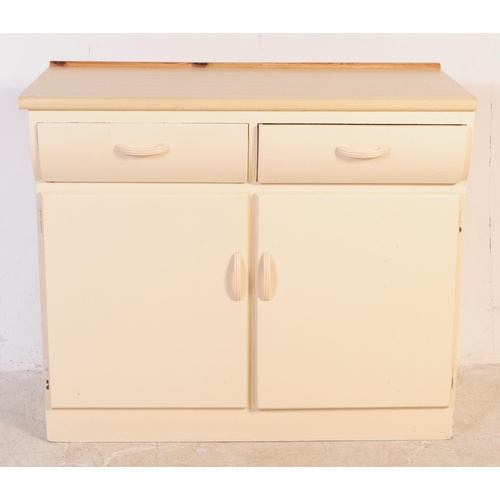 574 - Remploy - A retro mid 20th century Remploy cream kitchen unit / sideboard. The sideboard having cant... 