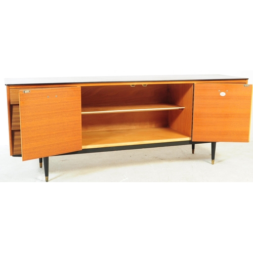 591 - Avalon Yatton - A retro mid 20th century walnut veneered sideboard credenza. Having pull down cabine... 