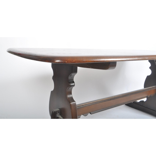 597 - Lucian Ercolani for Ercol Furniture - a 20th century beech and elm refectory dining table. Of curved... 