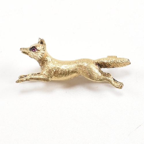 14 - A 19th century Victorian 15ct gold and ruby fox brooch pin. The brooch in the form of a running fox ... 