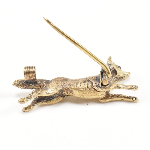 14 - A 19th century Victorian 15ct gold and ruby fox brooch pin. The brooch in the form of a running fox ... 