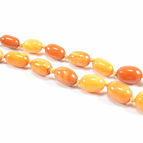 19 - A 1930S butterscotch amber bead necklace. The necklace strung with graduating beads from 2.2cm to 7m... 