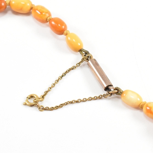 19 - A 1930S butterscotch amber bead necklace. The necklace strung with graduating beads from 2.2cm to 7m... 