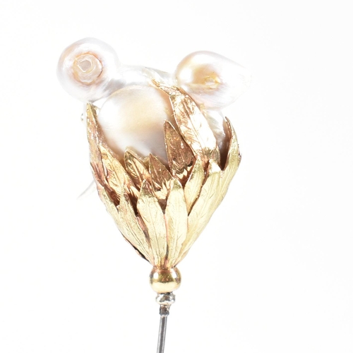 20 - An 18ct gold pearl elephant hat pin. The elephant formed of a baroque pearl having gem set eyes with... 