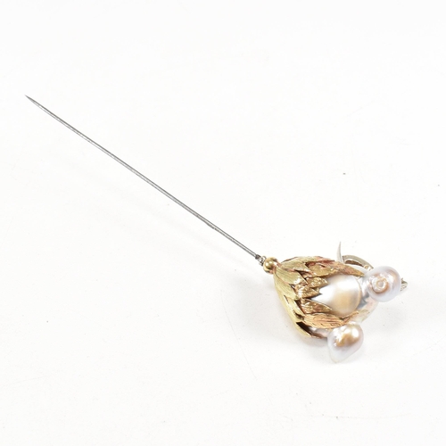 20 - An 18ct gold pearl elephant hat pin. The elephant formed of a baroque pearl having gem set eyes with... 