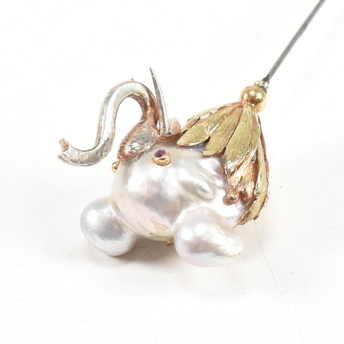 20 - An 18ct gold pearl elephant hat pin. The elephant formed of a baroque pearl having gem set eyes with... 