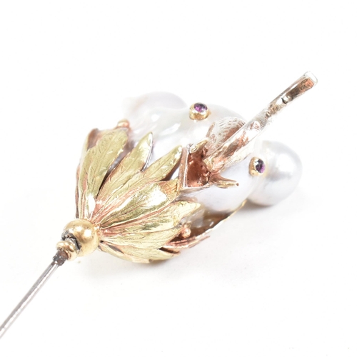 20 - An 18ct gold pearl elephant hat pin. The elephant formed of a baroque pearl having gem set eyes with... 