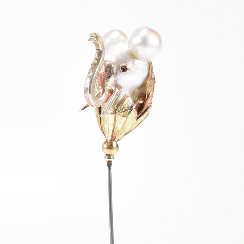 20 - An 18ct gold pearl elephant hat pin. The elephant formed of a baroque pearl having gem set eyes with... 