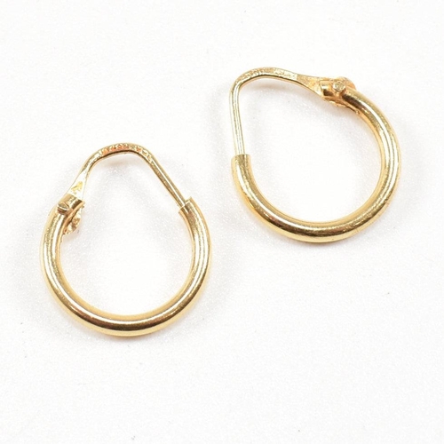A pair of 18ct gold hoop earrings. The earringÿ having marks to lever